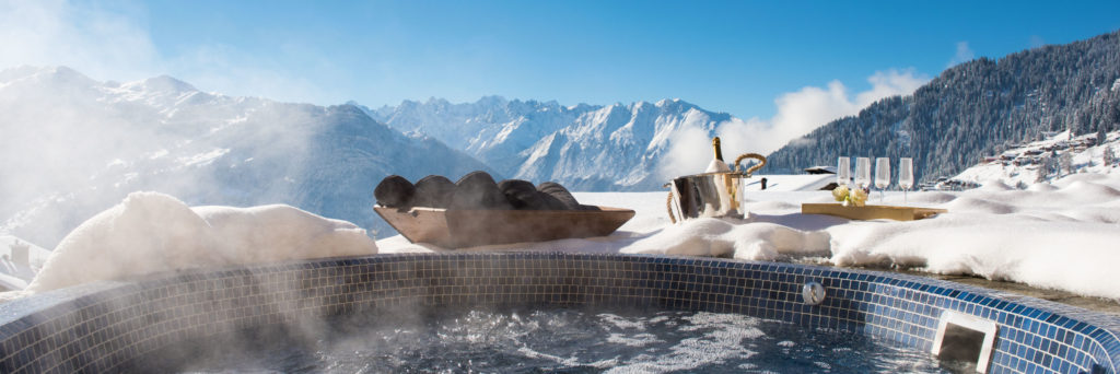 Outdoor hot tub with mountain views at Chalet Chouqui