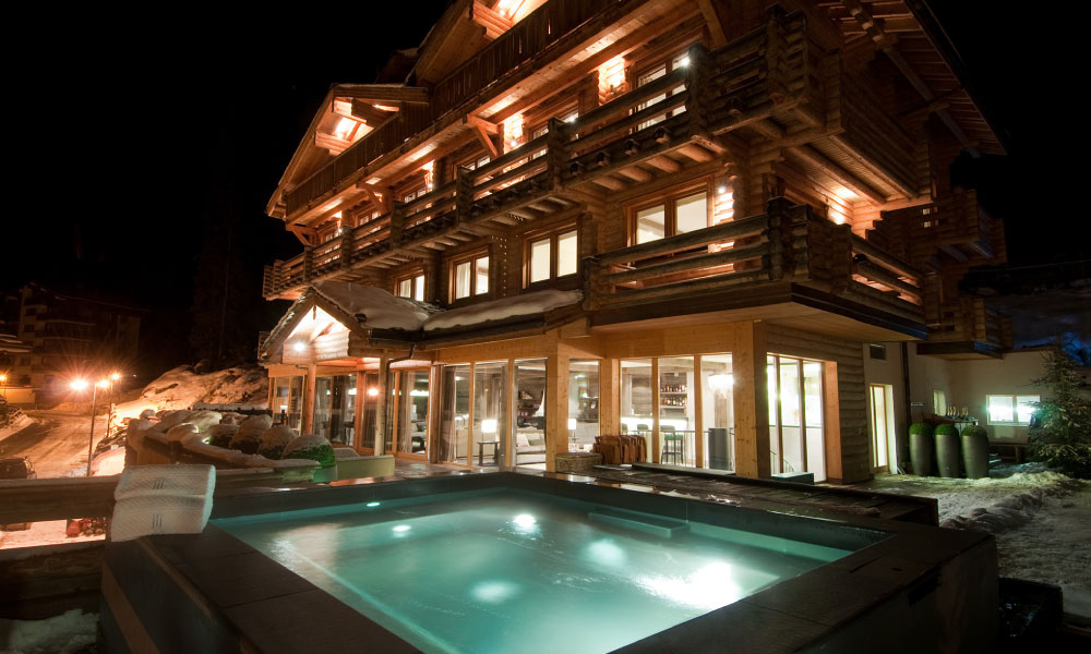 Outdoor hot tub and chalet view at The Lodge, Verbier