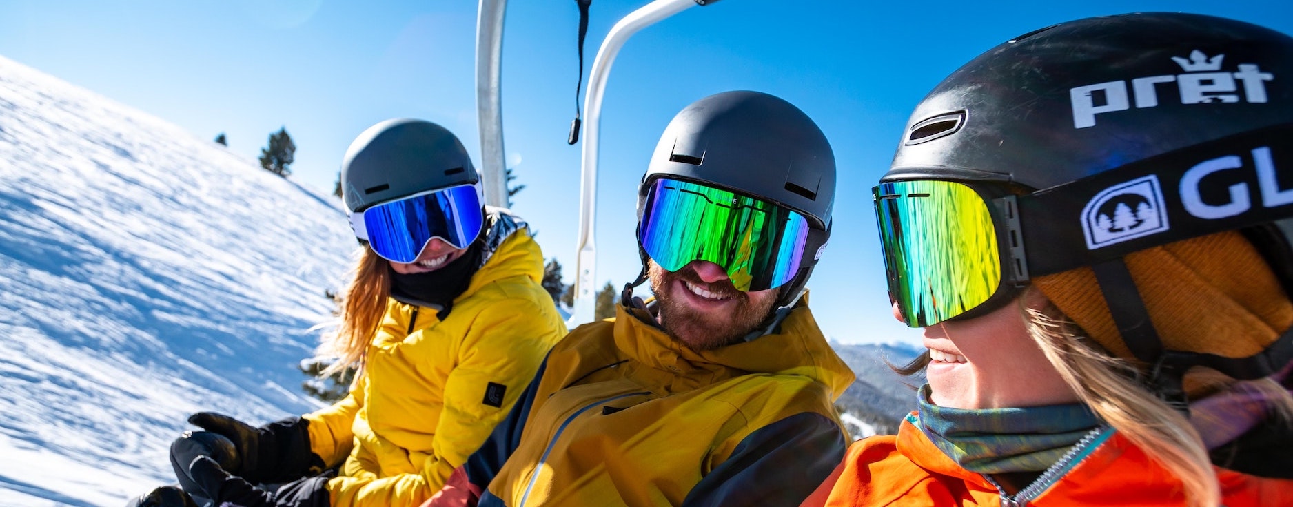 Three people on a ski chair lift