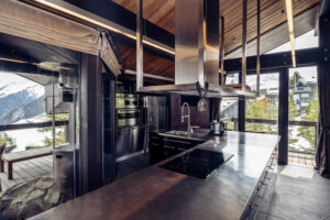 Kitchen area at Chalet Tahion with floor to ceiling windows behind